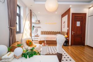 a bedroom with a bed and a living room at Katka Riverside Homestay Hai Phong in An Dương