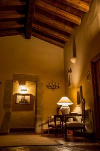 a living room with a table and a chair at Hotel Boutique Posada Dos Orillas in Trujillo