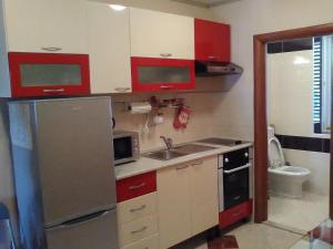 a small kitchen with a refrigerator and a sink at Studio Lucy in Split