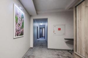 a hallway with white walls and a painting on the wall at Hotel Pod Jedlami in Wisła +61 photos