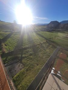 a view of a field with the sun in the sky at Cuore d'Altopiano, vivere Asiago in Asiago +3 photos