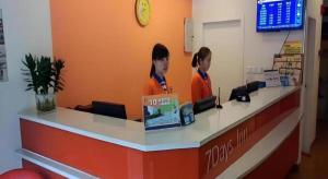 two women standing at a counter in a store at 7 Days Inn Tongren Railway Station Jintan in Tongren