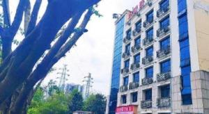 a tall building in front of a building at 7 Days Inn Chongqing Beibei New District Light Rail Station in Huangjuezhen