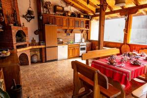 a kitchen with a table with a red table cloth at Guest House Comfort in Montana