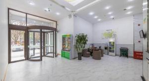 a lobby with a door and a potted plant at GreenTree Inn Lanzhou Gongjiawan Yangjiaqiao Express Hotel in Lanzhou
