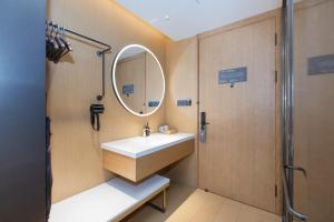 a bathroom with a sink and a mirror at JI Hotel Beijing Shangdi Nongda South Road in Beijing +27 photos