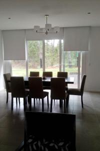 a dining room with a table and chairs at Pinamar Norte in Pinamar