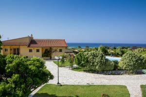 a view of a house and a swimming pool at Sandy Beach Villas and Apartments in Svoronata