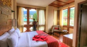 a bedroom with a bed with a red bow on it at The Pema by Realm in Thimphu