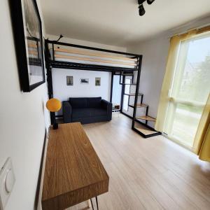 a living room with a couch and a table at Élégant appartement lumineux à Senlis in Senlis