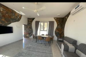 a living room with a couch and a table at Climbing Guest House Jebel Shams in Dār Sawdāʼ