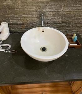 a white sink sitting on top of a counter at Mojosurf Red Island in Pulau Lutung +4 photos
