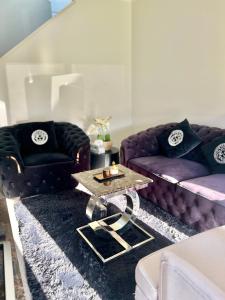 a living room with purple couches and a coffee table at Mahzan on Kilcunda - Ensuite 3 in Truganina