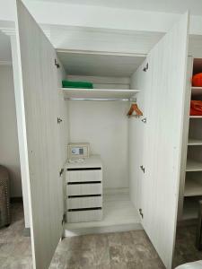 a room with a closet with a microwave on it at La Grande Residence 1BR Corner unit Phase 2-710 in Angeles +6 photos