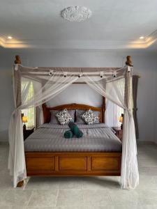 Postel nebo postele na pokoji v ubytování Sekumpul Guest House