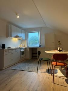 a kitchen with a table and chairs and a window at Gemütliche 2,5 Zimmer Wohnung in Grenzach-Wyhlen