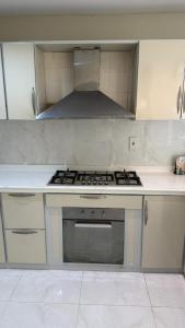 a kitchen with a stove and a stove top oven at فيلا السعادة بيتش درة العروس رملي وخاص in Durat  Alarous