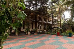 a building with a courtyard in front of it at Tulia Boutique Hotel & Spa in Arusha