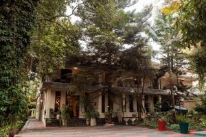 a house with trees in front of it at Tulia Boutique Hotel & Spa in Arusha