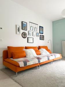 an orange couch sitting in a living room at Apartment near Treviso in Silea in Silea