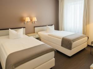 Postel nebo postele na pokoji v ubytování DORMERO Hotel Dessau-Roßlau + 28 fotografií