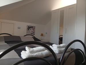 a bedroom with two beds with white towels on them at B&B Ariosto 26 in Rho +32 photos
