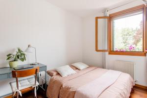 a bedroom with a bed and a desk and a window at Apartment near Treviso in Silea in Silea