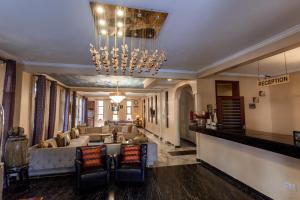 a large living room with a couch and a chandelier at Tulia Boutique Hotel & Spa in Arusha