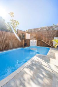a swimming pool in front of a fence at villa piscine jacuzzi in Petite Île