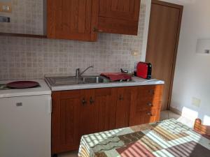 a kitchen with a sink and a counter top at Le sei palme B&B in Terralba +4 photos