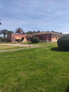 a field of grass with houses in the background at Le sei palme B&B in Terralba