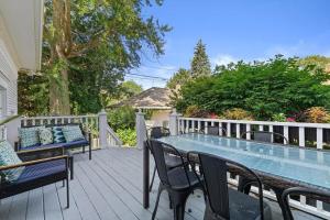a patio with a table and chairs on a deck at Gorgeous Historical Mansion on the Lake Front in Racine +51 photos