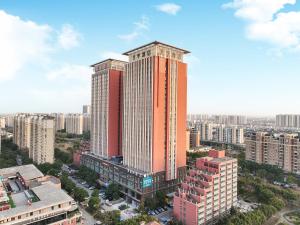 an overhead view of a tall building in a city at JI Hotel Shanghai Pudong International Airport Huinan in Shanghai