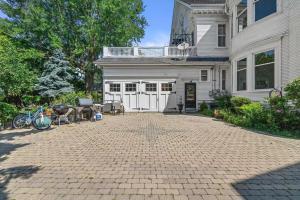 a large white house with a brick driveway at Gorgeous Historical Mansion on the Lake Front in Racine