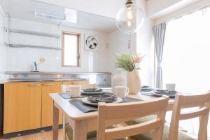 a kitchen with a table with chairs and a dining room at Ayame Building in Tokyo