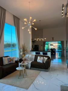 ein Wohnzimmer mit Sofa und Tisch in der Unterkunft Casa PWG Cânions - Sua casa de temporada no paraíso in Piranhas