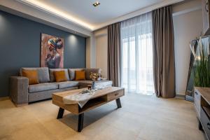 a living room with a couch and a coffee table at Aether, Light Modern Living in Gaïtánion