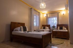 a bedroom with two beds and a window at Tulia Boutique Hotel & Spa in Arusha