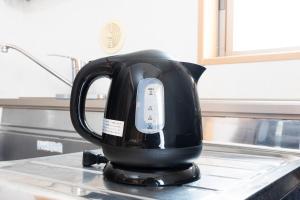 a black tea kettle sitting on top of a counter at Ayame Building in Tokyo