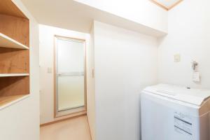 a laundry room with a washer and dryer and a window at Ayame Building in Tokyo +12 photos