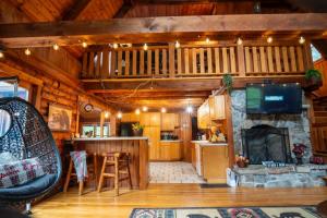 a living room with a fireplace in a log cabin at Perfect Family Cabin 3 Bedrooms in Northfield