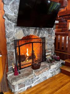 a stone fireplace with a fire place at Perfect Family Cabin 3 Bedrooms in Northfield