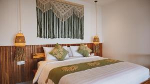 a bedroom with a large bed with pillows at Angsoka Villas Amed in Amed