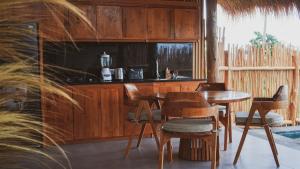 a kitchen with a table and chairs in a room at Angsoka Villas Amed in Amed