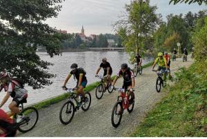 a group of people riding bikes along a river at Kuća za odmor Iva in Lič