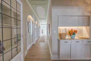a hallway with white cabinets and a ceiling at HOME-LYNN, 4 bedroom, Bloubergstrand in Bloubergstrand +77 photos