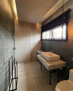 a bathroom with a sink and a shower and a toilet at Moonstone Villa Chiang Mai in Chiang Mai