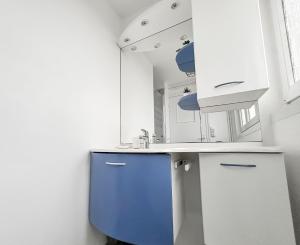a kitchen with a blue cabinet and a sink at Vue mer imprenable à Dunkerque, l'appel du large! in Dunkerque +18 photos