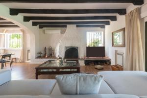 a living room with a couch and a fireplace at Villa Los Tres Almendros in Marbella