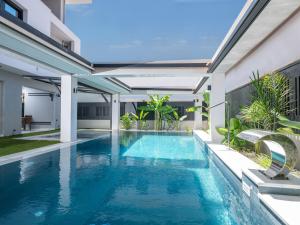 an indoor swimming pool with blue water in a house at Captain Napoleon Paterakis CNP Luxurious Suites in Heraklio